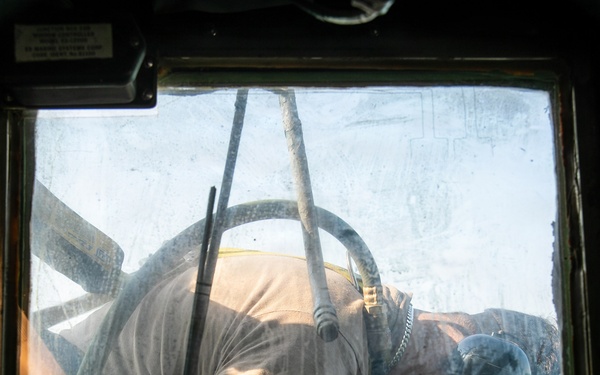 USS Mitscher (DDG 57) Sailor conducts deck preservation on bridge wing