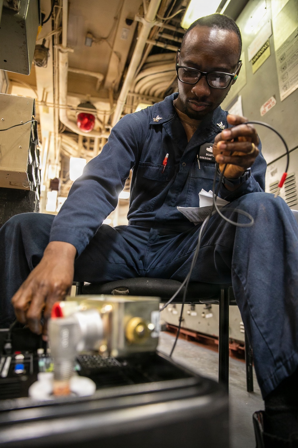 USS Mitscher (DDG 57) Sailor calibrates temperature switch