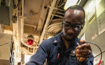 USS Mitscher (DDG 57) Sailor calibrates temperature switch