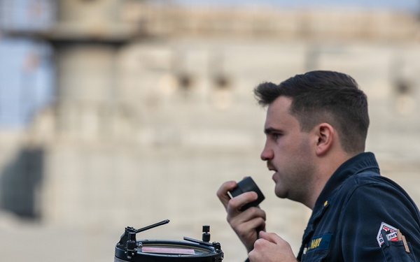 USS Mitscher (DDG 57) junior officer relays info on bridge wing during RAS with USNS Carl Brashear (T-AKE 7)