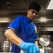 USS Mitscher (DDG 57) Sailor prepares food in ship galley