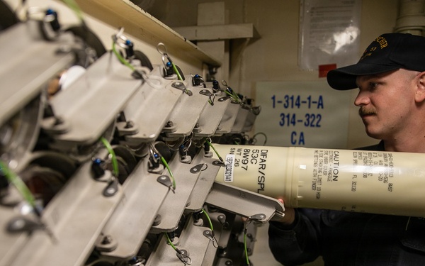 USS Mitscher (DDG 57) Sailor stows DICASS sonobouy units