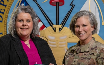 Ms. Sara Paul poses with Above and Beyond Award