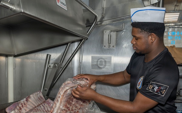 Culinary Specialists prepare dinner for the crew aboard USS Bulkeley (DDG 84)