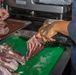 Culinary Specialists prepare dinner for the crew aboard USS Bulkeley (DDG 84)