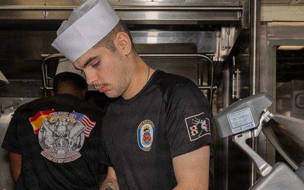 Culinary Specialists prepare dinner for the crew aboard USS Bulkeley (DDG 84)