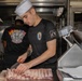 Culinary Specialists prepare dinner for the crew aboard USS Bulkeley (DDG 84)