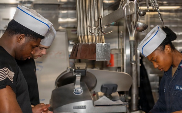 Culinary Specialists prepare dinner for the crew aboard USS Bulkeley (DDG 84)