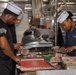 Culinary Specialists prepare dinner for the crew aboard USS Bulkeley (DDG 84)