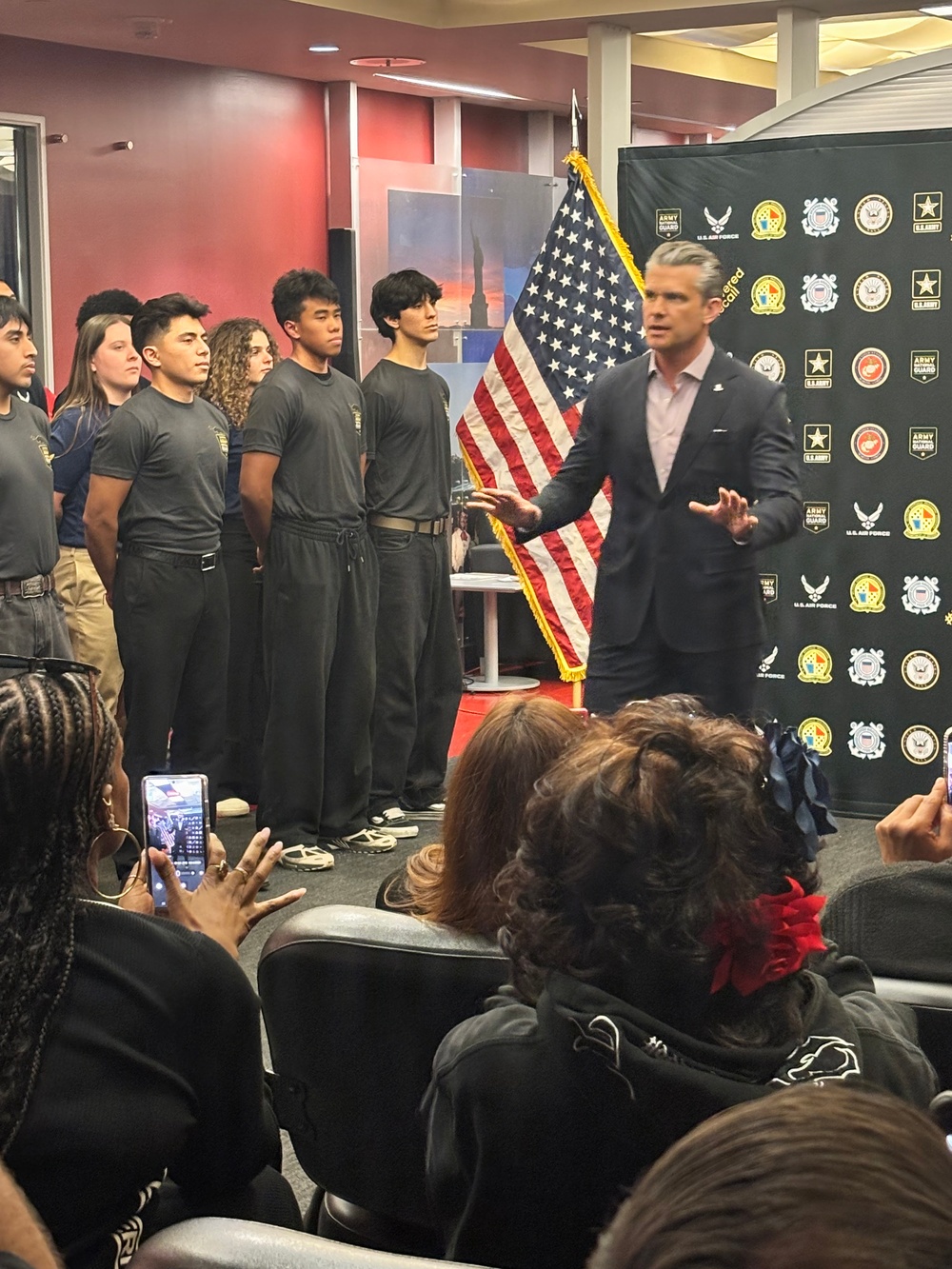 Secretary of War Pete Hegseth administers the oath of enlistment to Coast Guard and other military recruits in Southern California