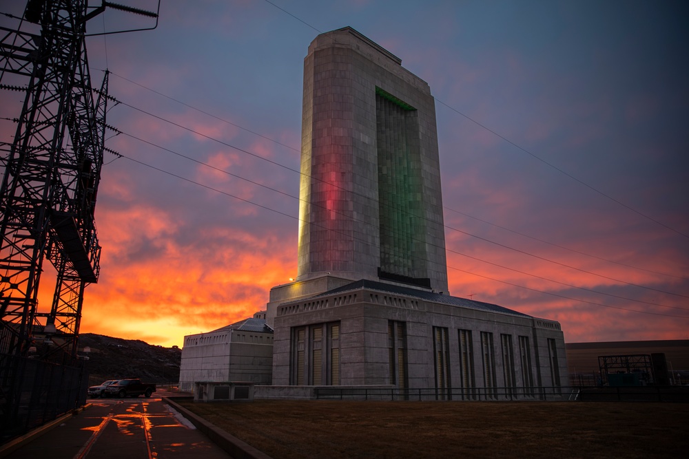 Morning sun peeks behind Fort Peck Dam powerhouse