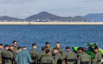 U.S. Marines practice with water survival gear in harbor