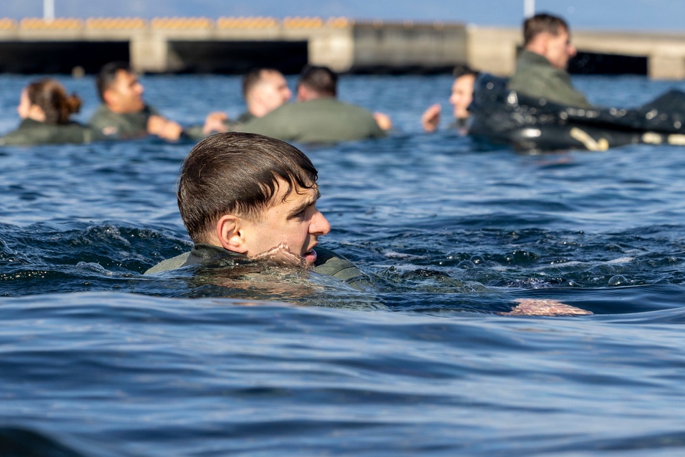U.S. Marines practice with water survival gear in harbor