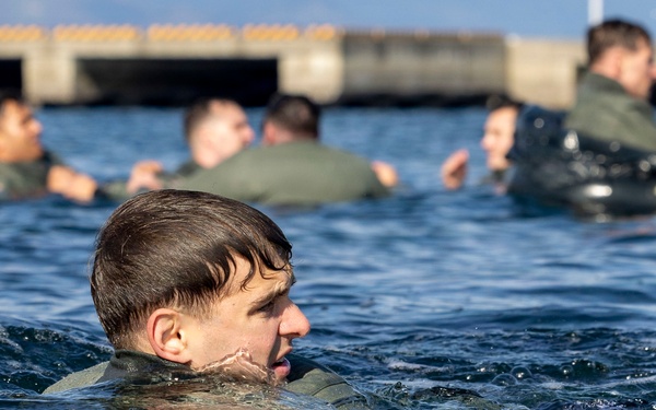 U.S. Marines practice with water survival gear in harbor