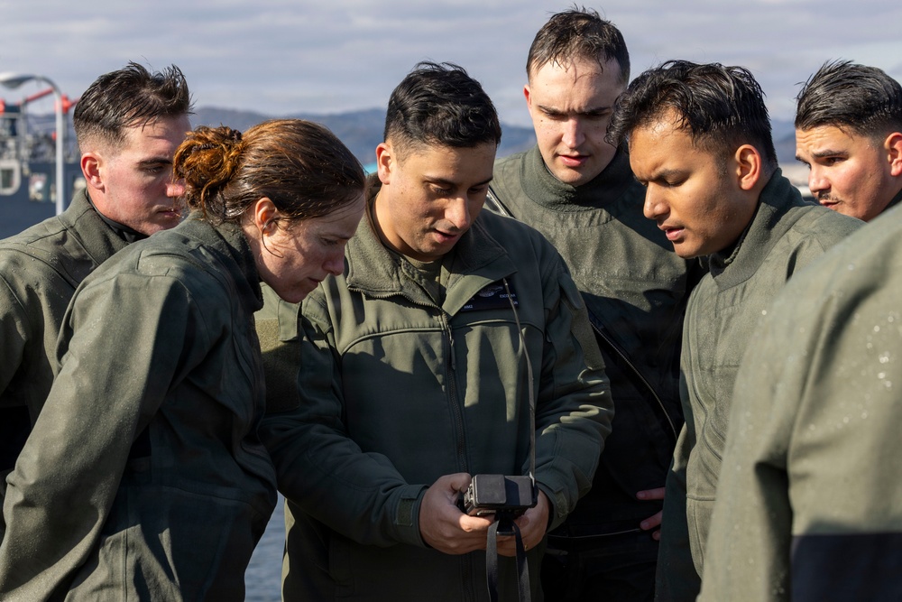 U.S. Marines practice with water survival gear in harbor
