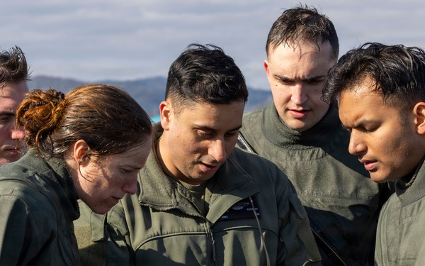 U.S. Marines practice with water survival gear in harbor