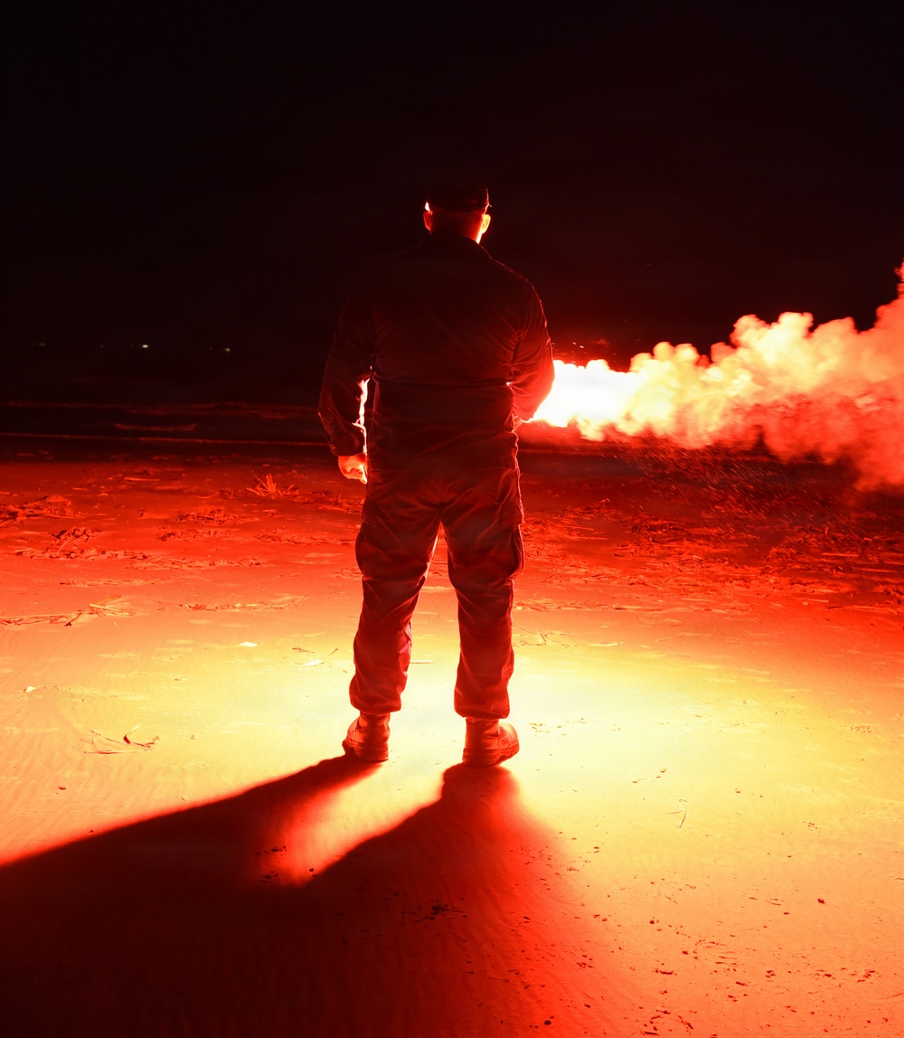 Coast Guardsman Trains with Light Flare
