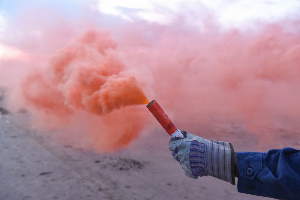 Coastguardsman Trains with a Smoke Flare