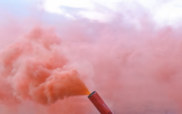 Coastguardsman Trains with a Smoke Flare