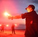 Coastguardsman Practices with Light Flare