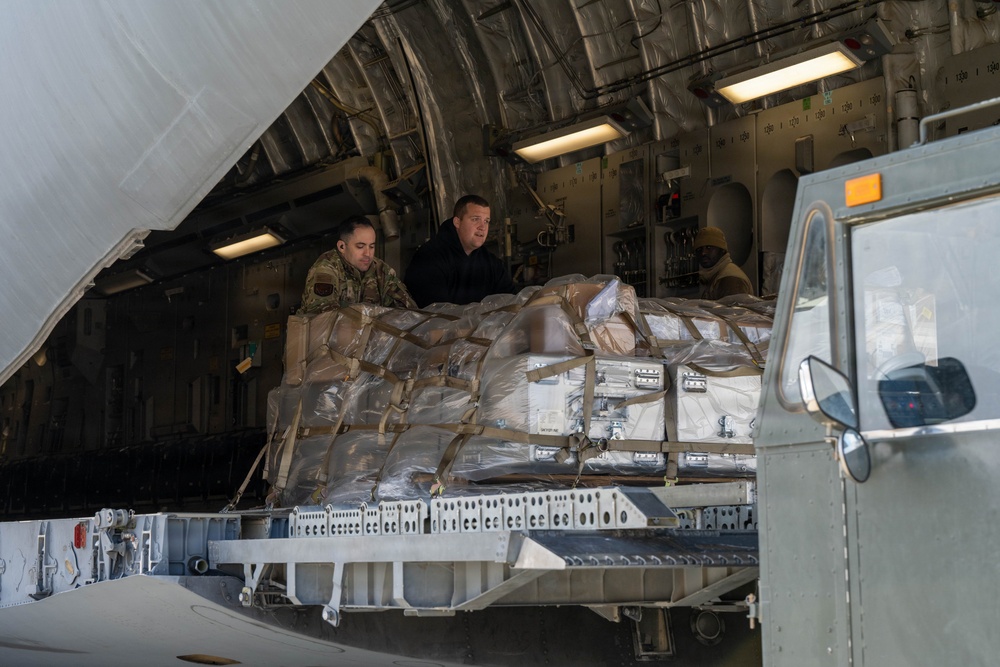 332nd Expeditionary Logistics Readiness Squadron loads pallets on C-17
