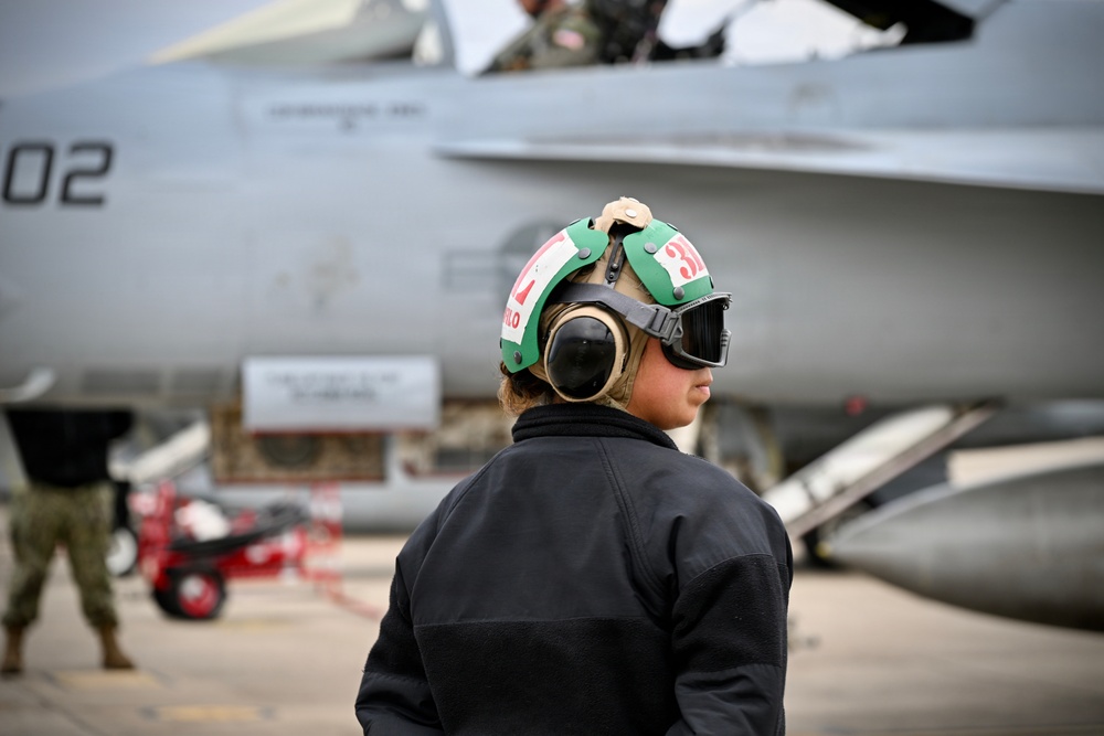 Sailor prepares an F/A-18E for takeoff at NAS Oceana