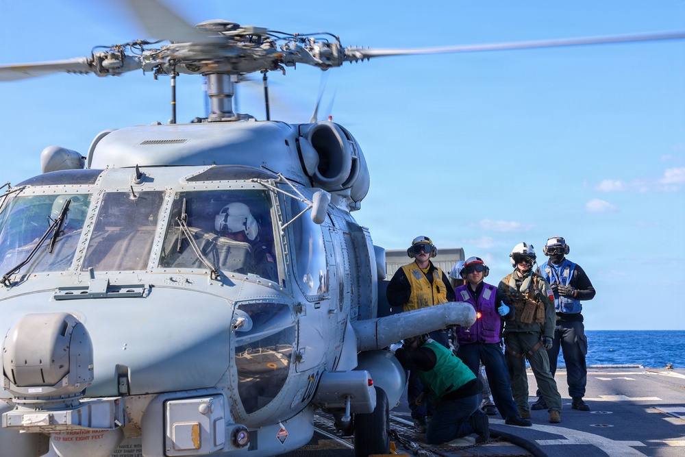 Sailors aboard the USS John Finn conduct flight quarters in the East China Sea