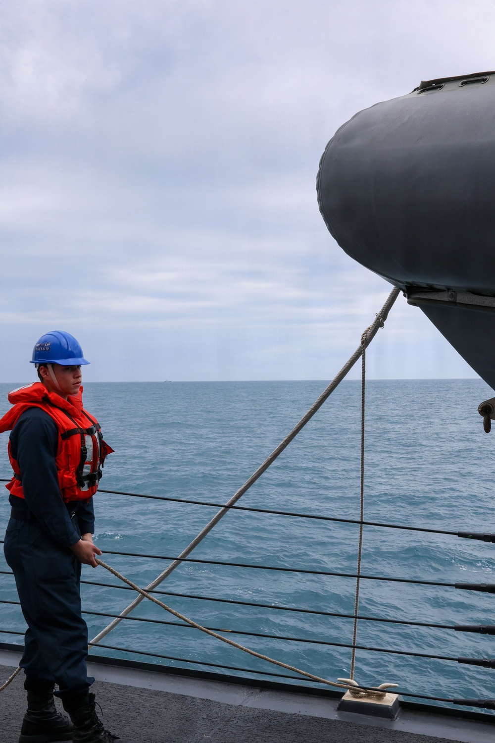 Sailors aboard the USS John Finn conduct small boat operations in the East China Sea
