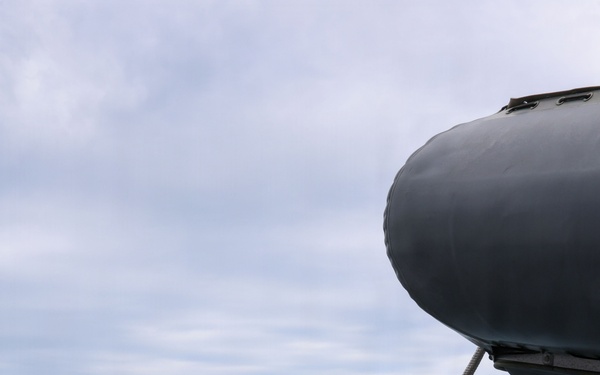Sailors aboard the USS John Finn conduct small boat operations in the East China Sea