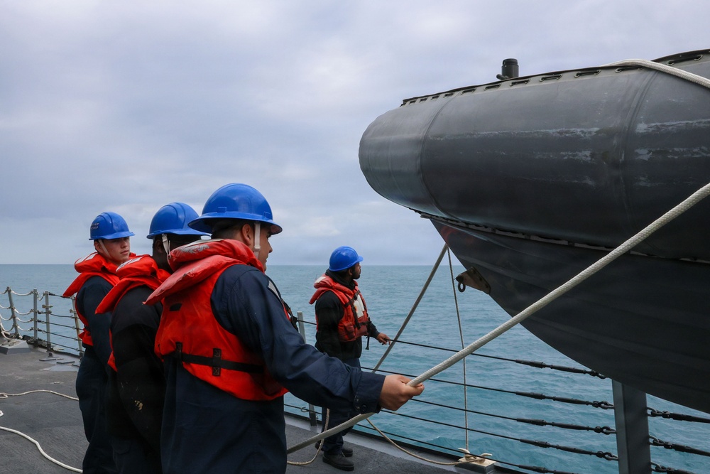 Sailors aboard the USS John Finn conduct small boat operations in the East China Sea