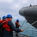 Sailors aboard the USS John Finn conduct small boat operations in the East China Sea