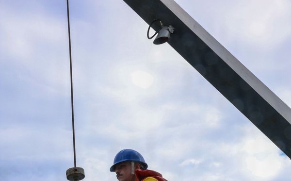 Sailors aboard the USS John Finn conduct small boat operations in the East China Sea