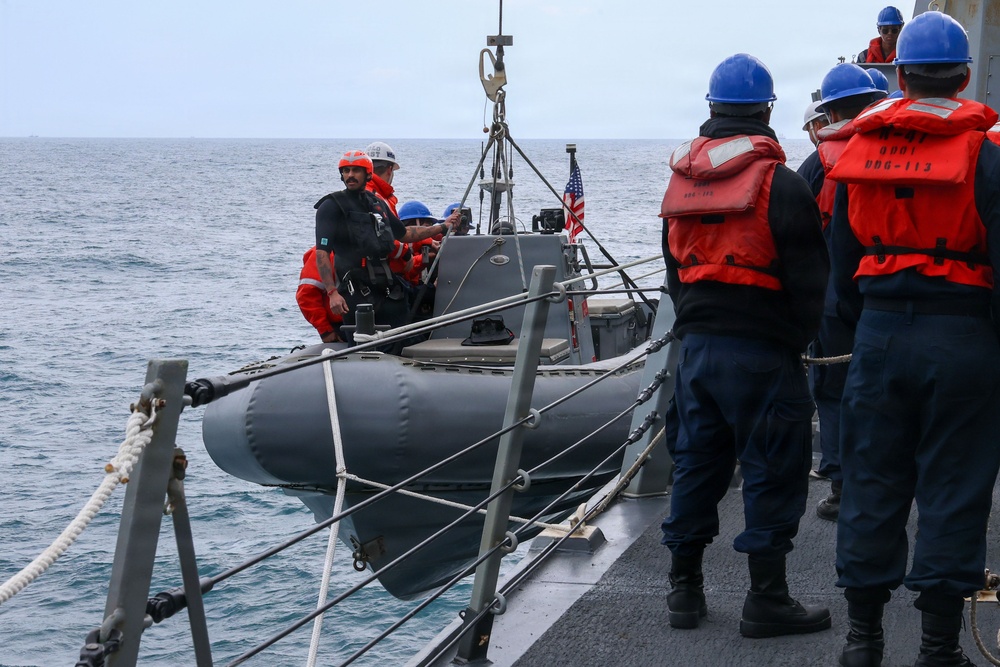 Sailors aboard the USS John Finn conduct small boat operations in the East China Sea