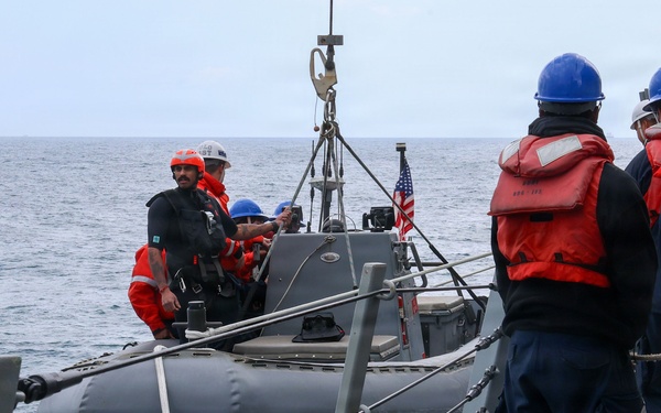 Sailors aboard the USS John Finn conduct small boat operations in the East China Sea