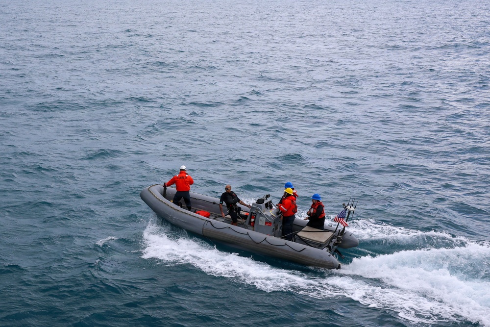 Sailors aboard the USS John Finn conduct small boat operations in the East China Sea