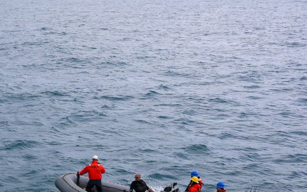 Sailors aboard the USS John Finn conduct small boat operations in the East China Sea
