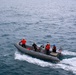 Sailors aboard the USS John Finn conduct small boat operations in the East China Sea