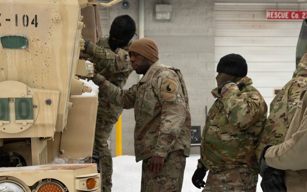 Soldiers Conduct Vehicle Maintenance in Snow