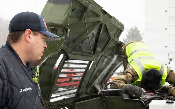 Soldier Conducts Vehicle Maintenance in Snow