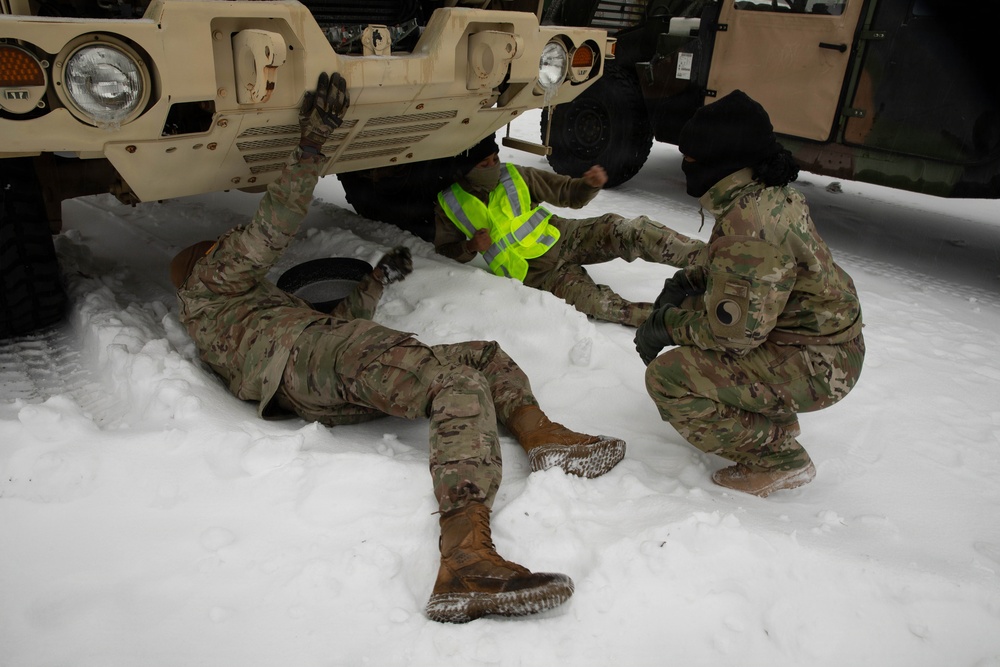 Soldiers Conduct Vehicle Maintenance in Snow