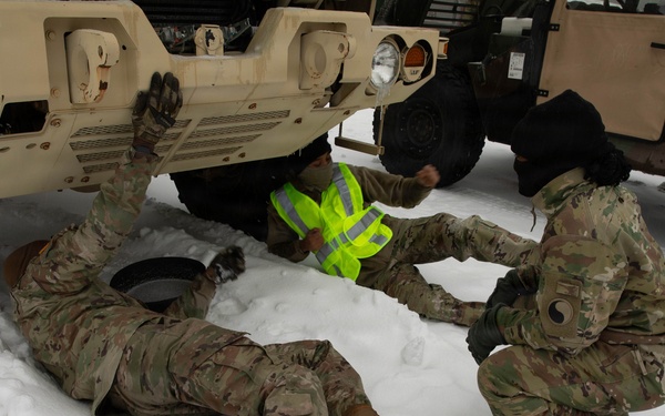 Soldiers Conduct Vehicle Maintenance in Snow