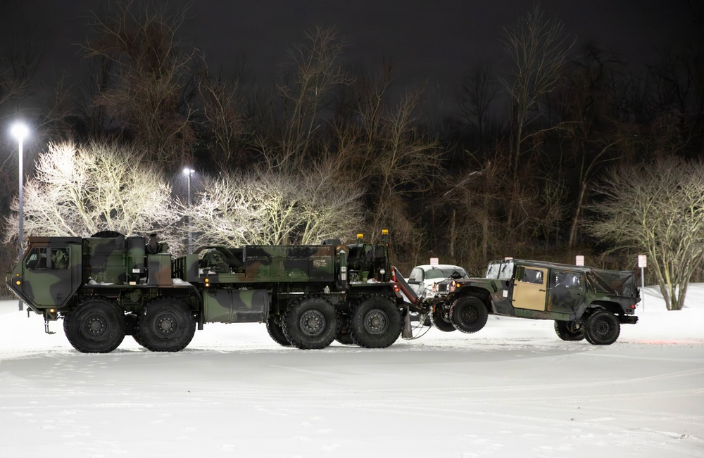Military Vehicle Towed in Snow