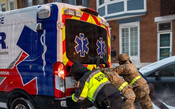 Maryland Army National Guard Soldiers and Paramedics from Old Town Fire Station Push an Ambulance Out of the Snow