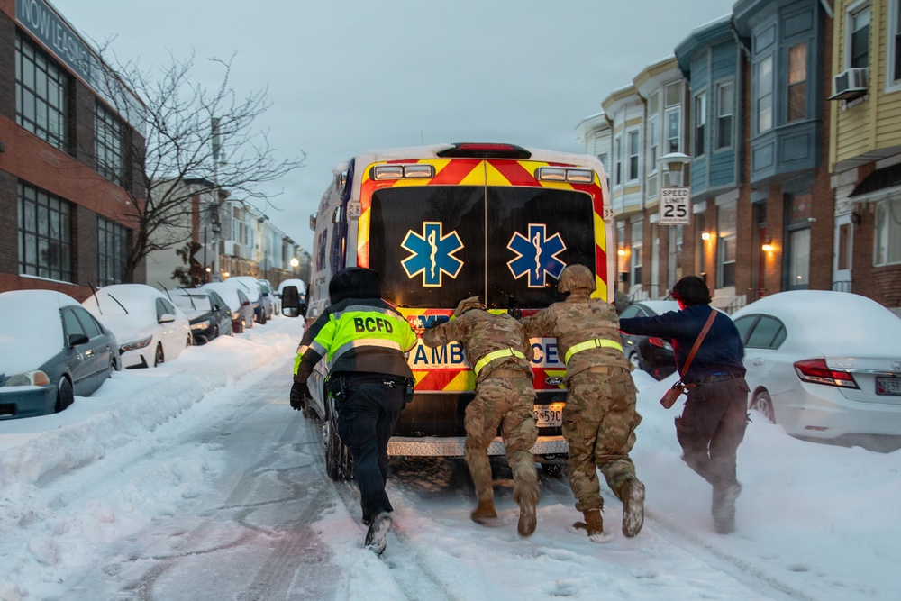 Maryland Army National Guard Soldiers and Paramedics from Old Town Fire Station Push an Ambulance Out of the Snow