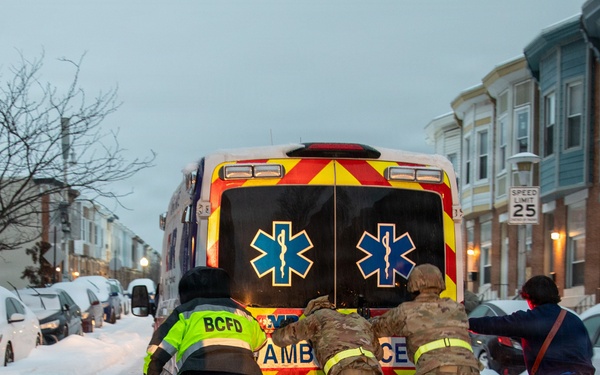 Maryland Army National Guard Soldiers and Paramedics from Old Town Fire Station Push an Ambulance Out of the Snow