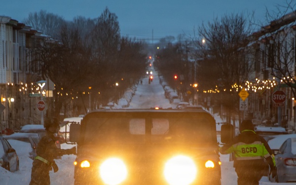 Maryland Army National Guard Spc. Nathan Hillegass and Asher Leeder, a Paramedic with the Old Town Fire Station, Enter Their HMMWV