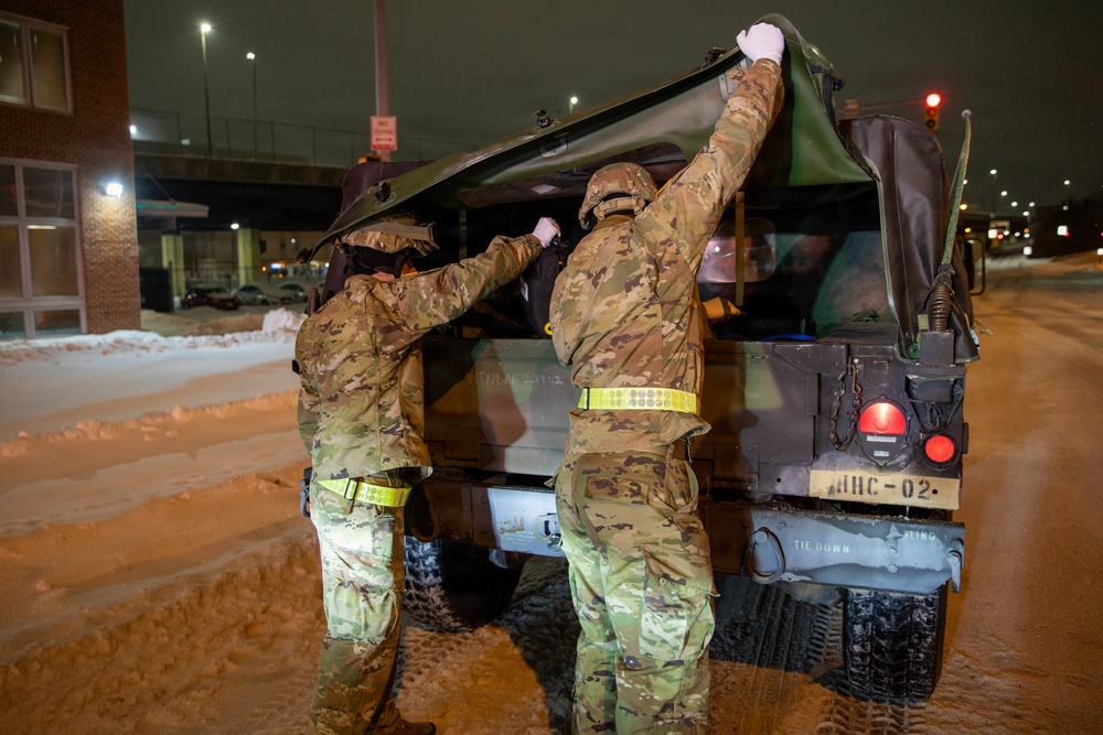 Maryland Army National Guard Cadet Deandre Wright and Spc. Nathan Hillegass Place Medical Equipment into a HUMVEE