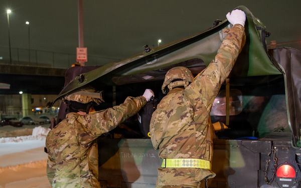 Maryland Army National Guard Cadet Deandre Wright and Spc. Nathan Hillegass Place Medical Equipment into a HUMVEE