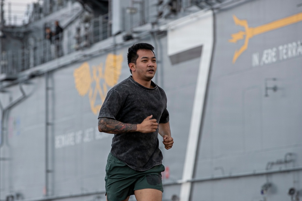 Sailors and Marines Run on the Flight Deck Aboard USS Tripoli