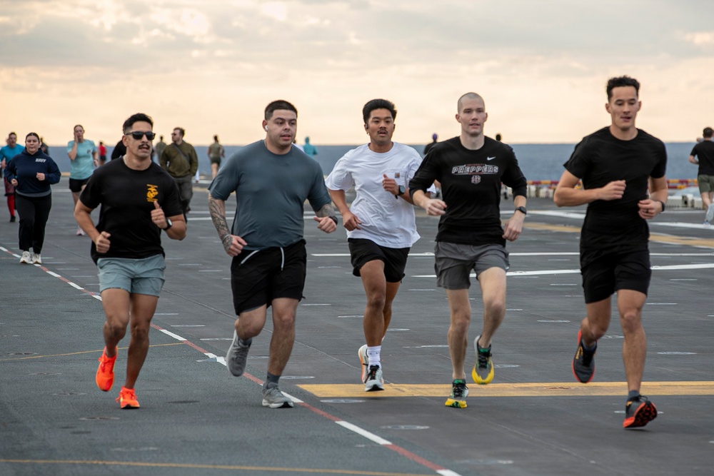 Sailors and Marines Run on the Flight Deck Aboard USS Tripoli